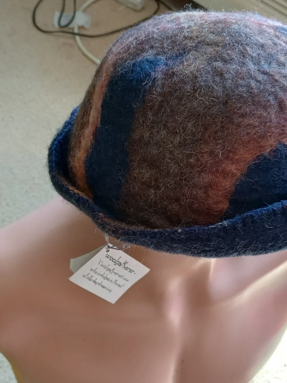 Sgailean handmade blue and rust-colored felted wool cloche hat.